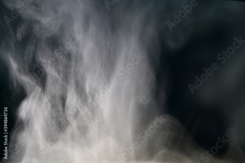 Grey smoke on a black background, fog on a dark background