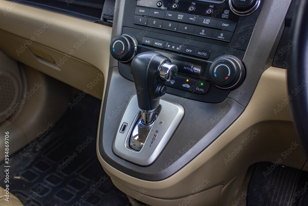 Fototapeta premium automatic transmission shift selector in the car interior. Closeup a manual shift of modern car gear shifter.