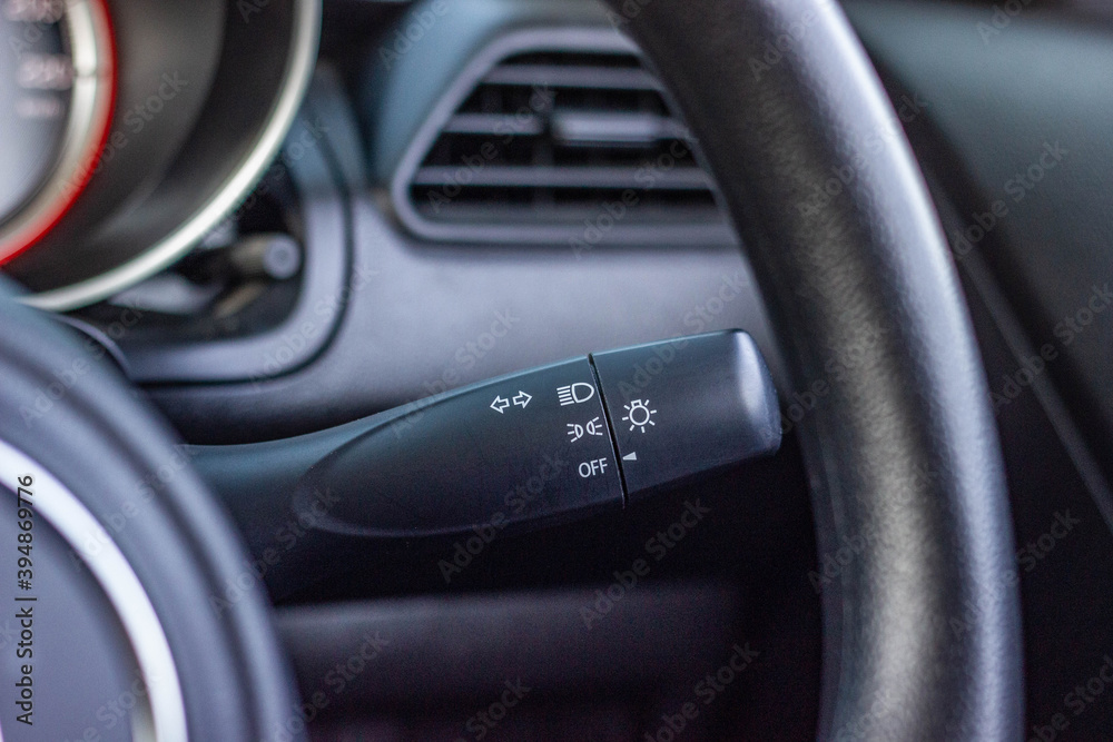 Switch off lights in a car. close-up Car integrated turning indicator with headlight switch toggle. Switch off lights in a car. close-up Car integrated turning indicator with headlight switch toggle.