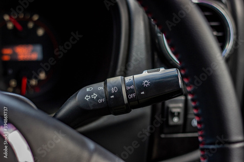 Switch off lights in a car. close-up Car integrated turning indicator with headlight switch toggle.