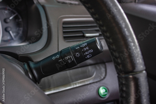 Switch off lights in a car. close-up Car integrated turning indicator with headlight switch toggle. © Muanpare