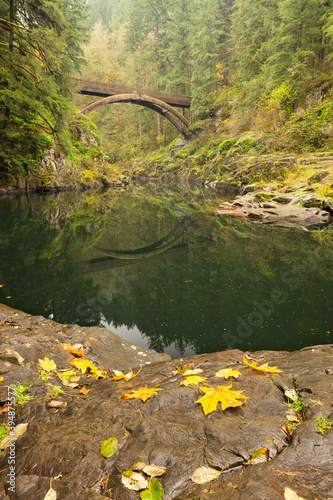 Nature bridge reflected in the still waters of the Lewis River in Washington State