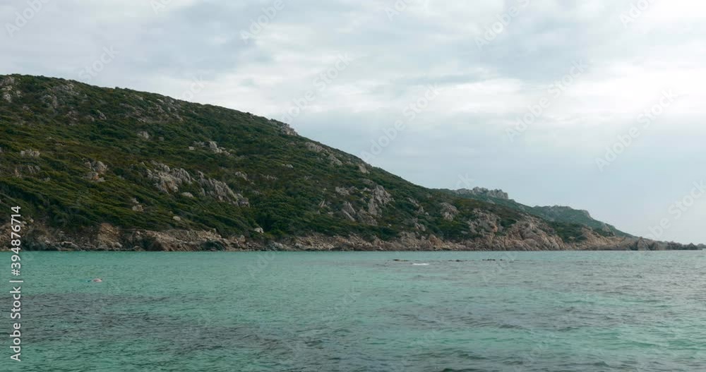 Beautiful view of the sea with mountains in background, man is swimming into the mediterranean sea surrounded by mountains
Beautiful view of the sea with mountains in background, man is swimming into the mediterranean sea surrounded by mountains