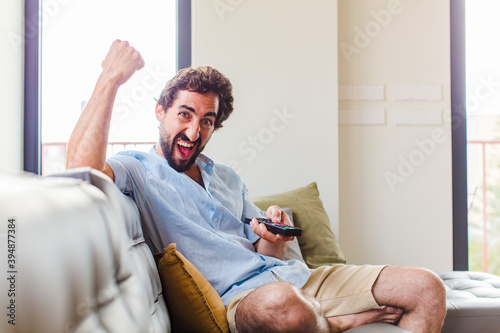 bearded man shouting aggressively with an angry expression or with fists clenched celebrating success photo