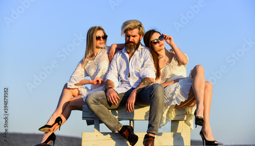 fashion and beauty. Love triangle. friendship and love relations. spend free time together. outdoor lifestyle and summer activity. handsome man and sexy girl friends relax outdoor