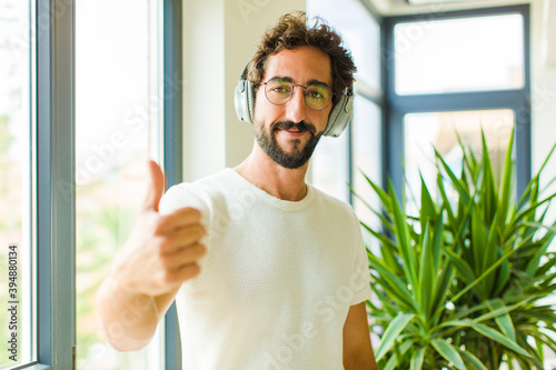 young bearded man listening music with his headphones photo