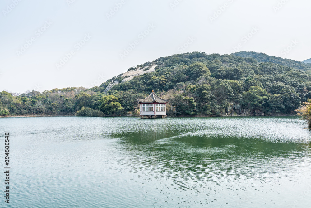 Chinese traditional pavilion next to lake in the Putuoshan mountains, Zhoushan Islands, a renowned site in Chinese bodhimanda of the bodhisattva Avalokitesvara (Guanyin) Chinese traditional pavilion next to lake in the Putuoshan mountains, Zhoushan Islands, a renowned site in Chinese bodhimanda of the bodhisattva Avalokitesvara (Guanyin)