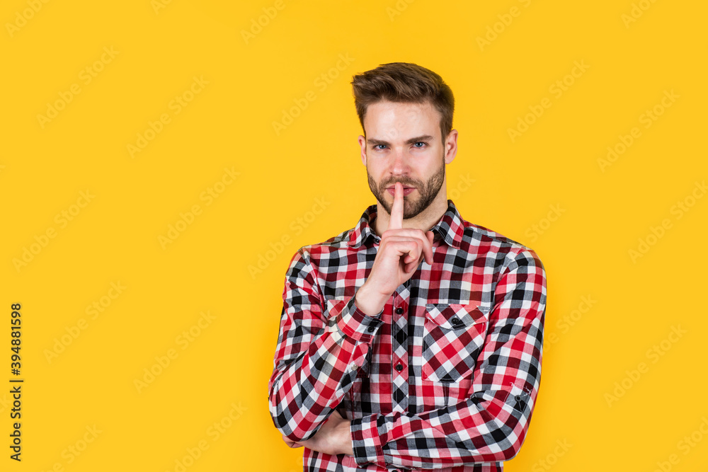 keep the secret. handsome casual man standing with beard and bristle. cheerful and stylish. handsome man on red background. portrait of sexy european businessman. confident and calm. copy space keep the secret. handsome casual man standing with beard and bristle. cheerful and stylish. handsome man on red background. portrait of sexy european businessman. confident and calm. copy space