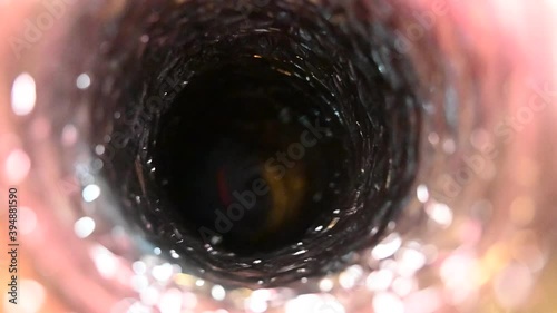 Spinning brush being used to clean out flexible tubing pipe HVAC duct 