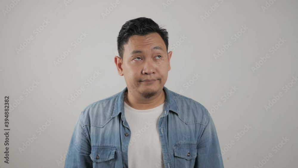 Young Asian man closing his ears dont want or avoiding to hear bad news, stress under mental pressure