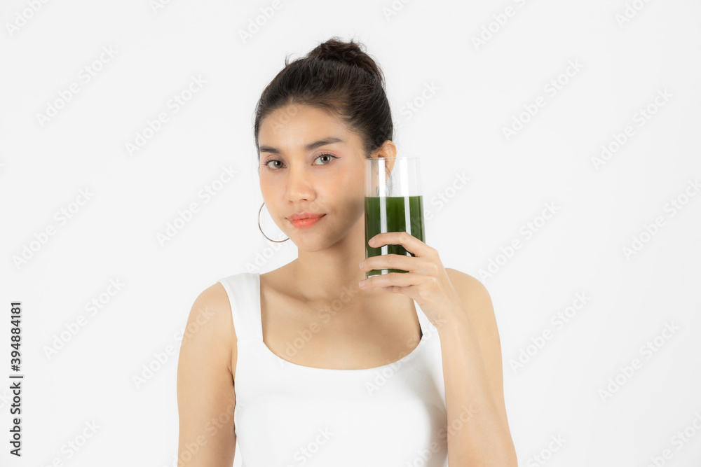 Beautiful young Asian woman drinking green detox vegetable smoothie over white isolated background. Fitness and health care concept, Vegetarian drink juice, Healthy lifestyle. Beautiful young Asian woman drinking green detox vegetable smoothie over white isolated background. Fitness and health care concept, Vegetarian drink juice, Healthy lifestyle.
