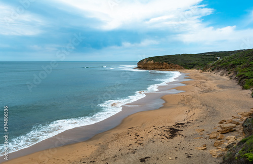 Panoramic view from hill Bells beach cliff with surfers in water cloudy sky iconic surfing spot Australia Victoria state Great ocean road