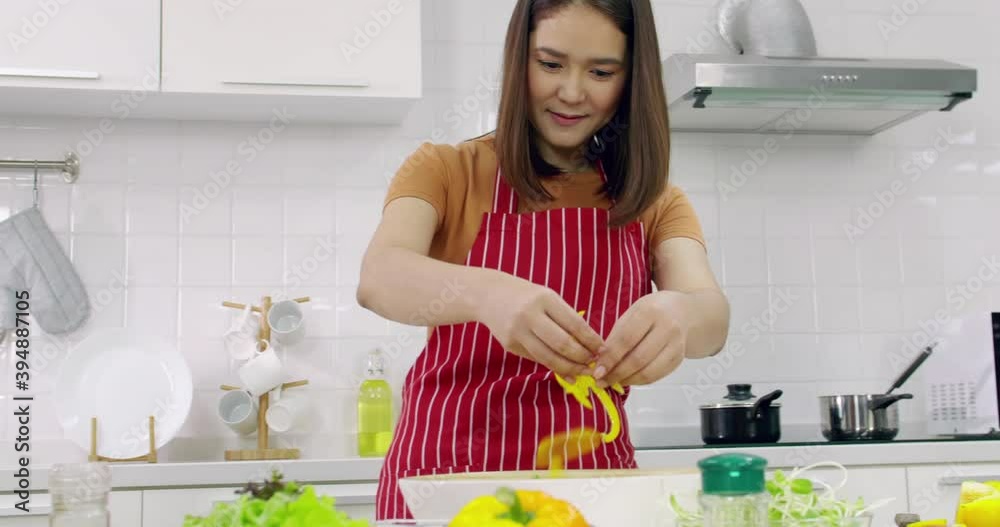 Young Asian woman cooking in kitchen at home. Young Asian woman cooking in kitchen at home.