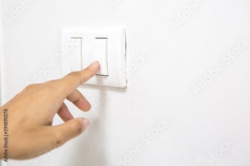 A woman's finger is pressing a switch  and copy space