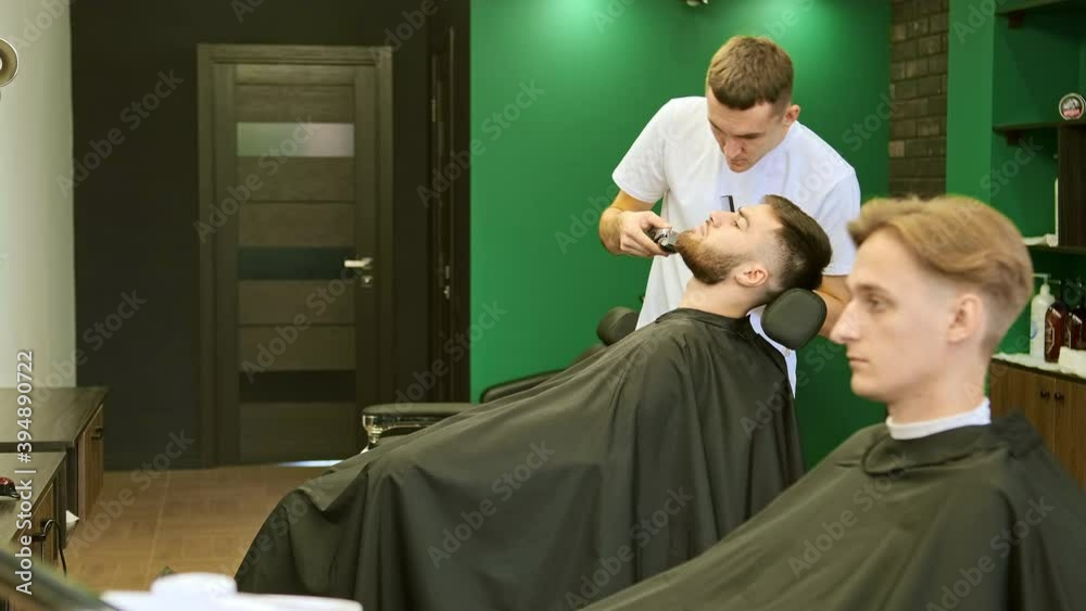 stylist hold plastic comb and trimmer cutting beard slow motion stylist hold plastic comb and trimmer cutting beard slow motion