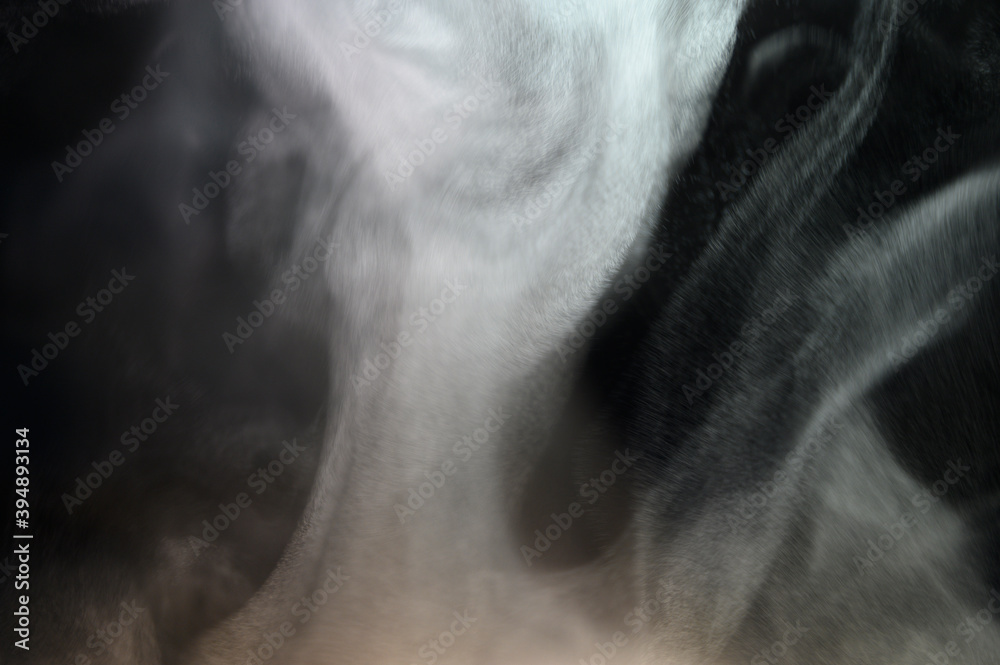 Grey smoke on a black background, fog on a dark background