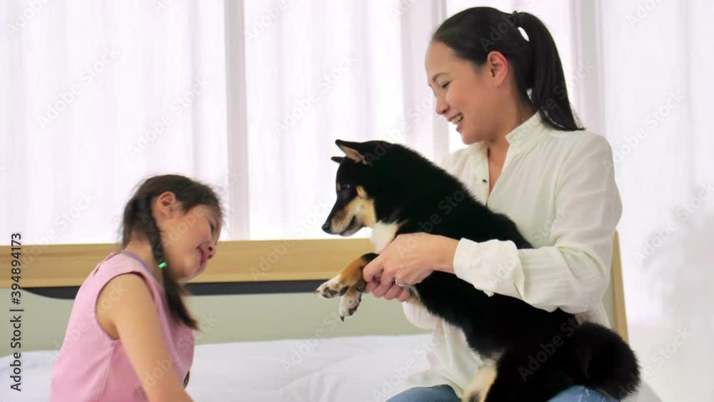 Mother and little daughter with their dog spending time together at home. Mother and little daughter with their dog spending time together at home.