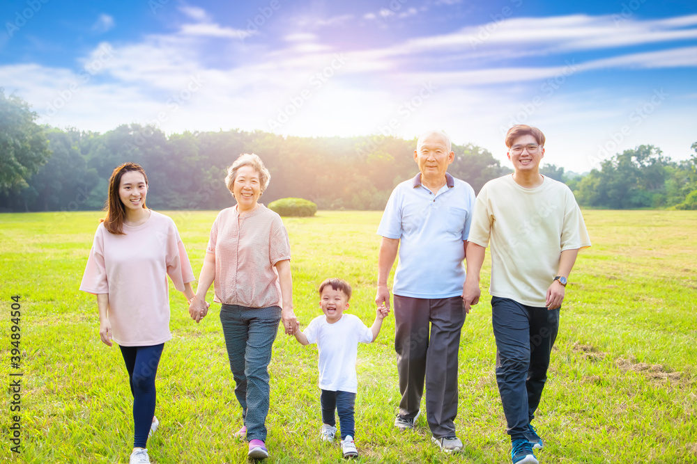 three generation asian family walking in the park three generation asian family walking in the park