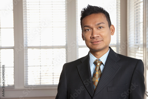 Smiling Malaysian businessman in office photo