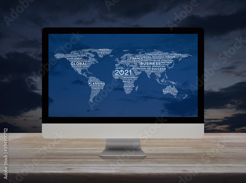 Start up business flat icon with global words world map on desktop modern computer monitor screen on wooden table over sunset sky, Happy new year 2021 global business start up concept, Elements of thi