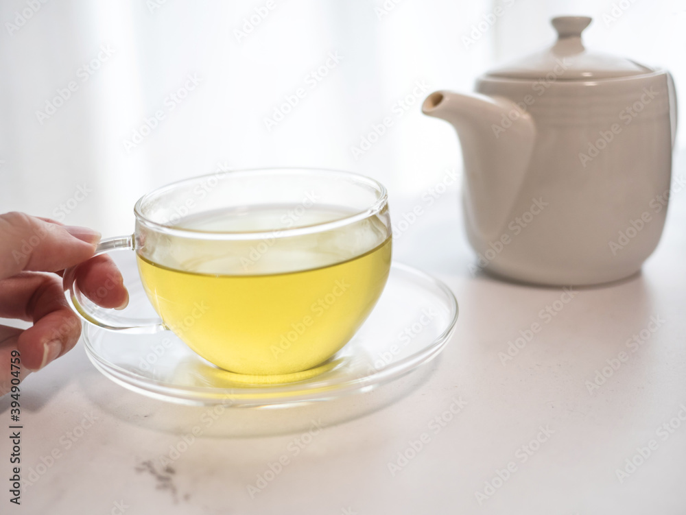 透明耐熱グラスに急須で注がれた緑茶・日本茶を家で飲む様子。