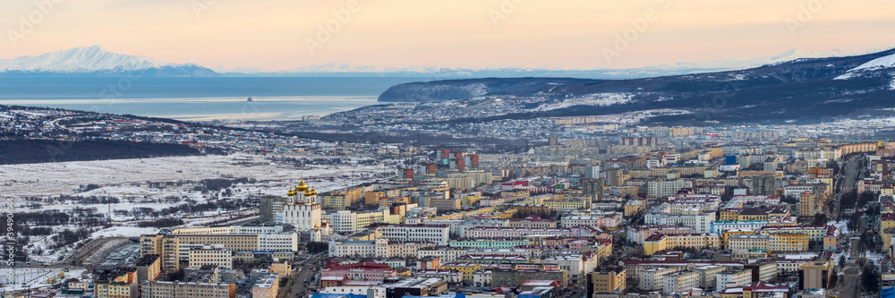 Panorama of the city of Magadan. Northern Russian city on the coast of the Sea of ​​Okhotsk. Winter city landscape. Aerial view of the streets and buildings. Magadan, Magadan region, Siberia, Russia.