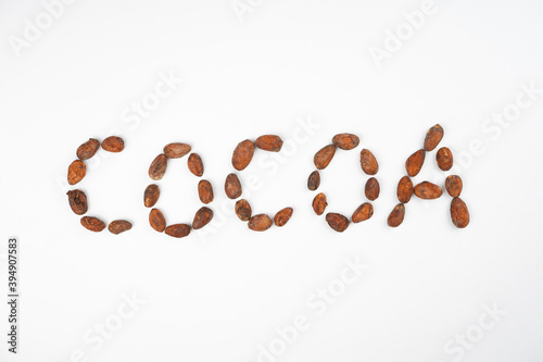 Word COCOA from beans on white background. Chocolate  dessert  recipe  menu concept. Top view  flat lay  copy space