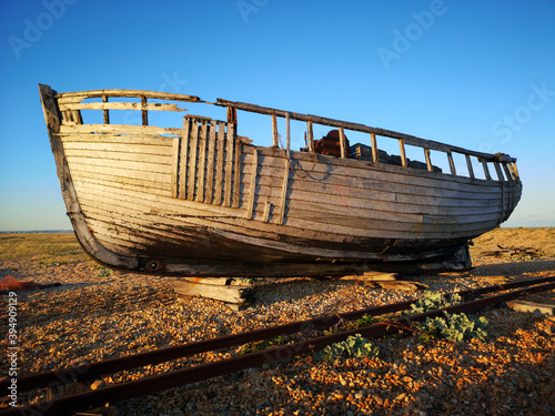 Old fishing boat on Dungeness beach. High and dry on the shingle beach and rotting away over the years. 