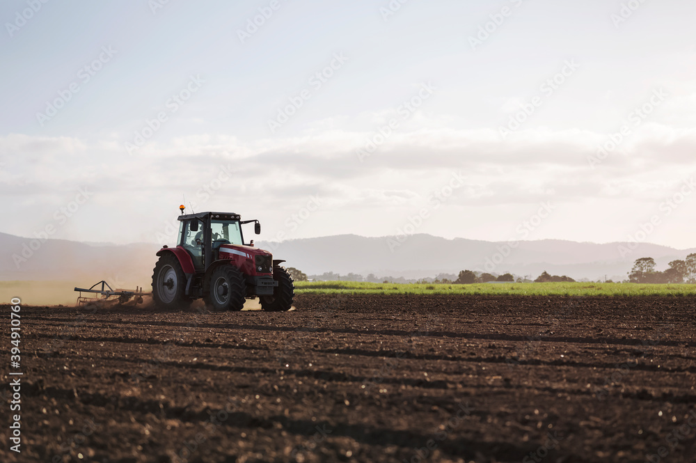 Tractor ploughing and preparing field for new crop Tractor ploughing and preparing field for new crop