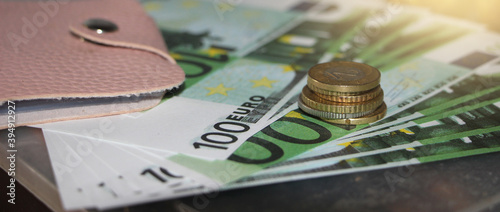 Pink leather wallet and 100 Euro banknotes. Money concept. Buying, shopping, selling and reselling business concept