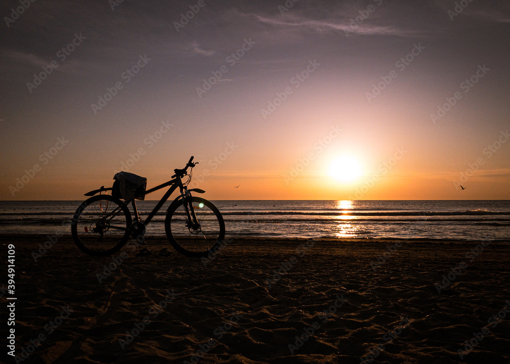 bicycle parked on the evening beach