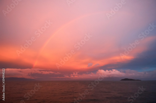 Islands and rainbow at sunset in the Verde Island Passage between Batangas and Sabang Beach - Philippines photo