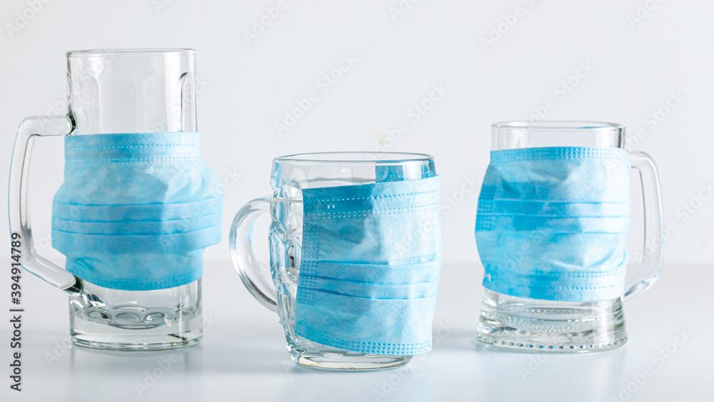 Naklejka premium Three masked beer mugs. Coronavirus restriction in pub