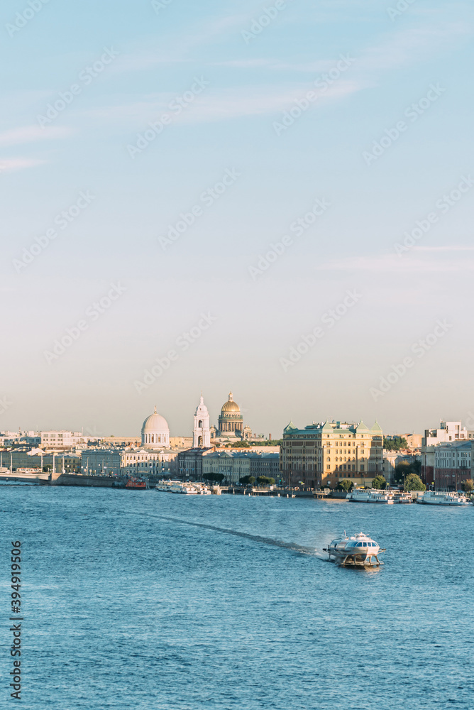 Saint-Petersburg, Russia, 18 August 2020: A passenger meteor boat sailing along Malaya Neva river. View of Vasilievsky Island, dome of Saint Isaac's Cathedral.