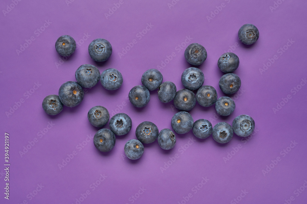 Creative layout made of blueberry on violet background. Flat lay. Food concept. Macro concept. Creative layout made of blueberry on violet background. Flat lay. Food concept. Macro concept.