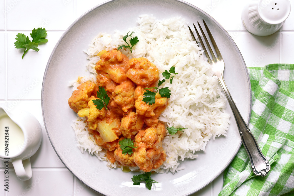 Vegan cauliflower curry with rice. Top view with copy space. Vegan cauliflower curry with rice. Top view with copy space.