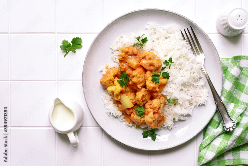 Vegan cauliflower curry with rice. Top view with copy space. Vegan cauliflower curry with rice. Top view with copy space.