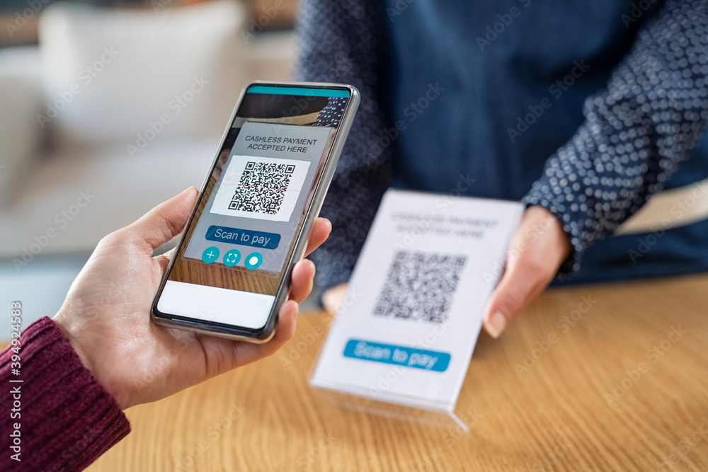 Customer hand scanning qr code with phone for digital payment Customer hand scanning qr code with phone for digital payment