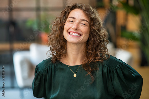 Satisfied business woman laughing at office photo