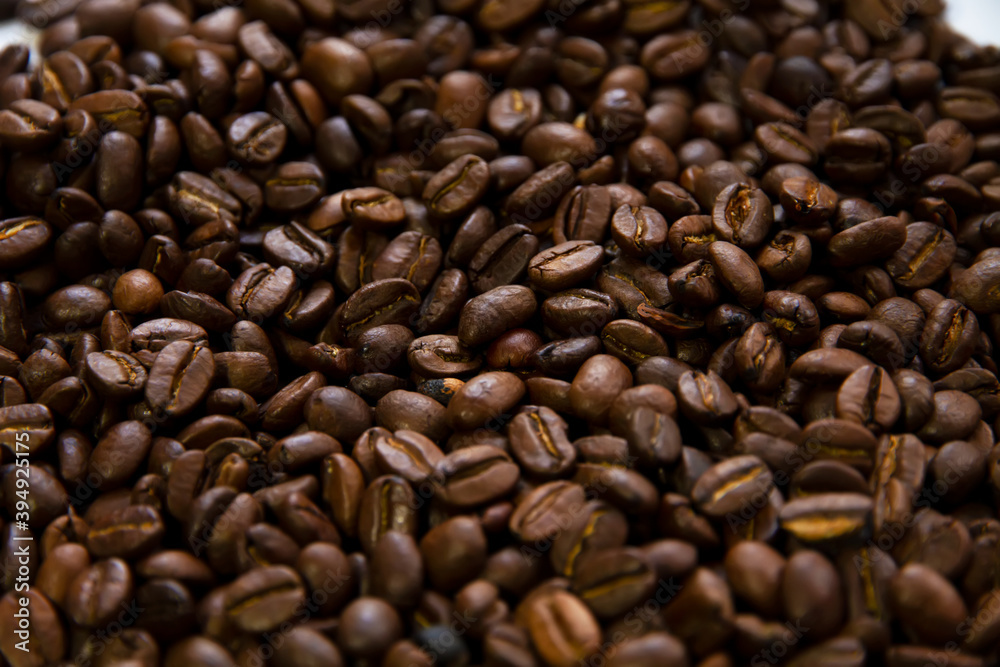 Roasted coffee beans heap isolated on white background can be used as background Roasted coffee beans heap isolated on white background can be used as background