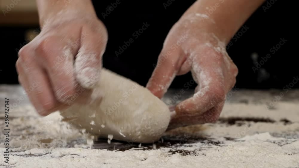 Close-up of kneading dough with flour on the table. Close-up of kneading dough with flour on the table.