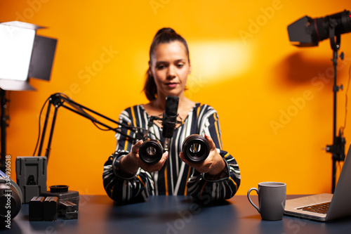 Photography vloger recording video while testing new lens for his camera. New media star influencer on social media talking video photo equipment for online internet web show. photo