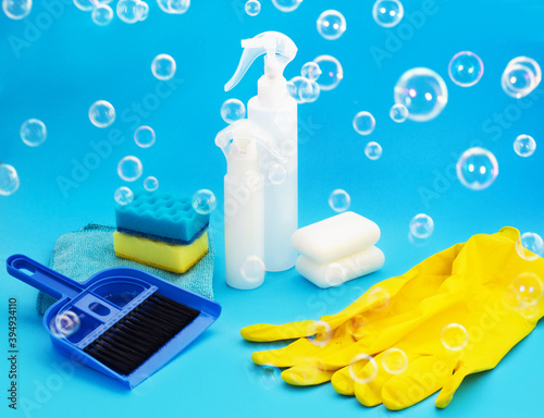 Household chemicals products and Supplies on Blue Background with bubbles. Cleaning Services Concept. Washing equipment