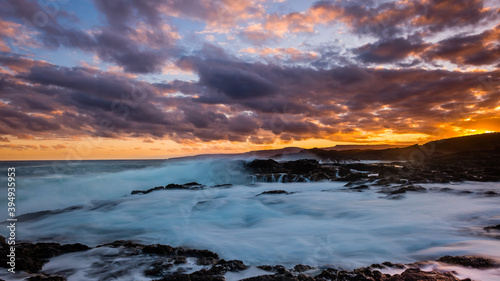 Sunset sky and water waves at Bushrangers Bay