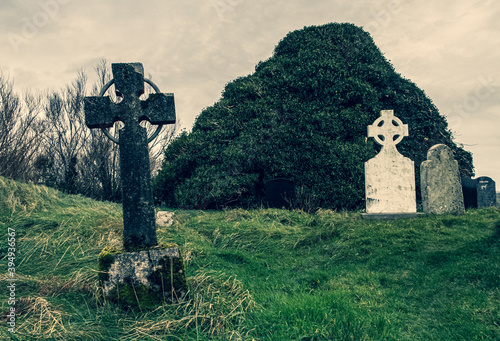Ireland celtic cross at medieval church cemetery
Old spooky cemetery . Haunted cemetery. Scary place. Old graves