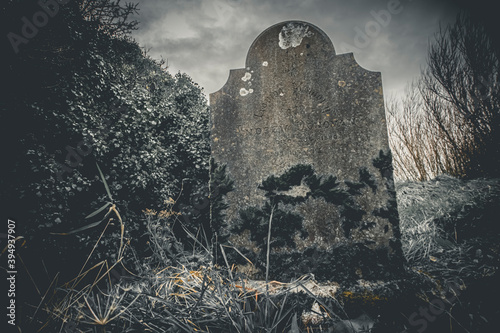 Ireland celtic cross at medieval church cemetery Old spooky cemetery . Haunted cemetery. Scary place. Old graves