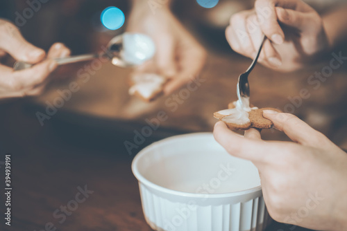 Women preparing cookies for Christmas or New Year party at home ( cinematic color grading)