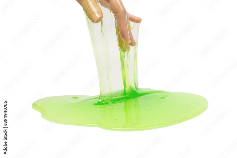 Fototapeta premium Green slime toy in woman hand isolated on white background.