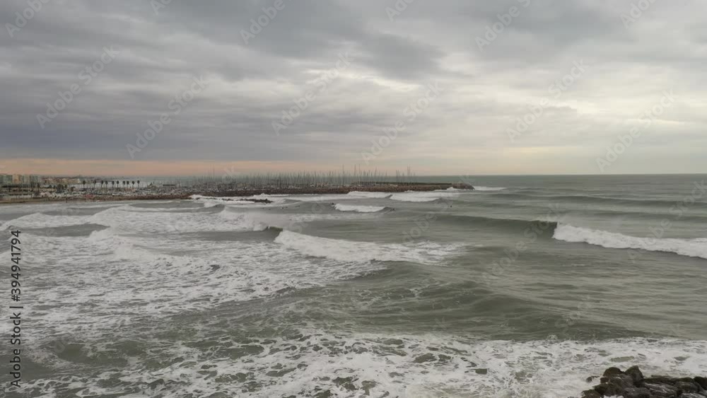 Aerial view of surfers, on the waves, with bad weather. French coastal town near the Mediterranean sea
Aerial view of surfers, on the waves, with bad weather. French coastal town near the Mediterranean sea