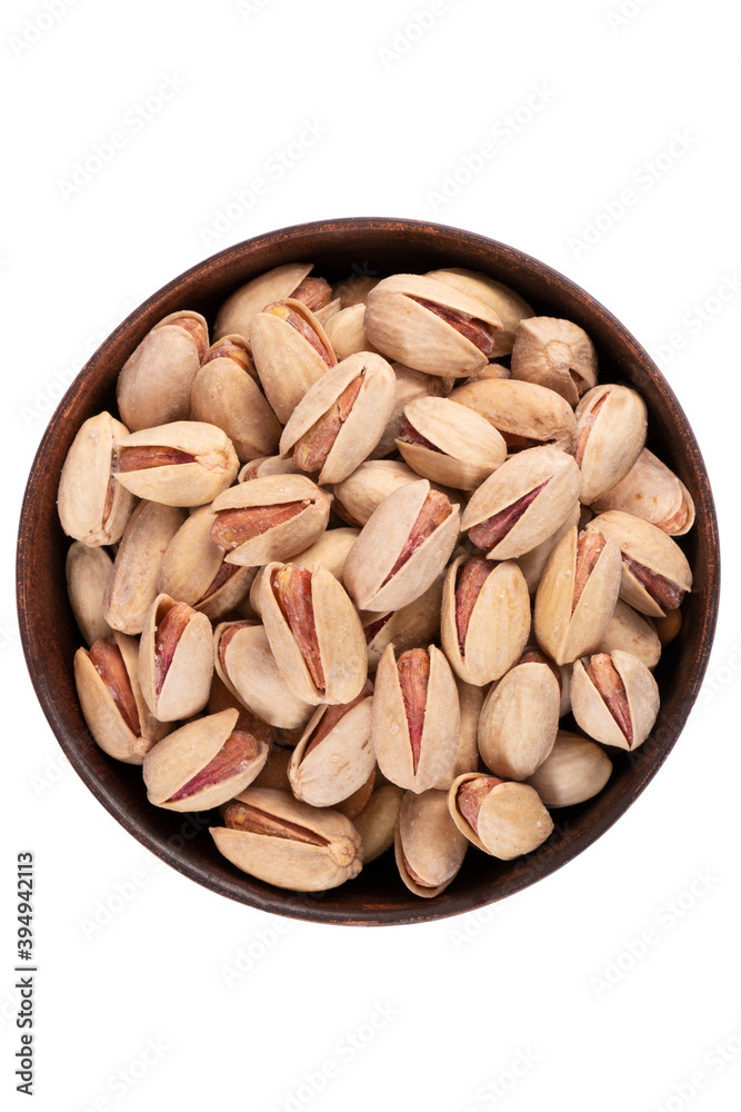 pistachio nuts in a round plate isolated on white pistachio nuts in a round plate isolated on white